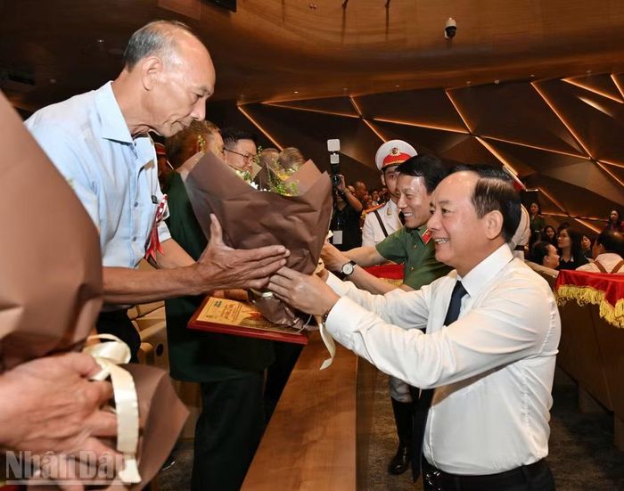 Đồng chí Trịnh Văn Quyết và đồng chí Đại tướng Lương Tam Quang tặng hoa và quà tri ân các Mẹ Việt Nam anh hùng, Anh hùng Lực lượng vũ trang nhân dân, thương binh, bệnh binh và người có công với cách mạng. (Ảnh: THỦY NGUYÊN)
