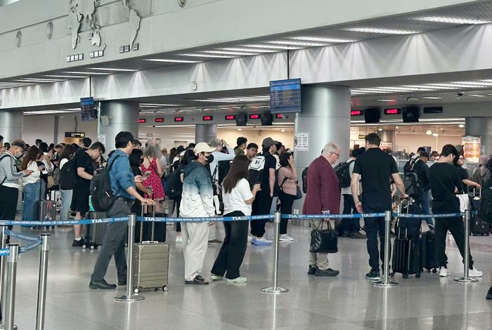  Hành khách xếp hàng chờ làm thủ tục tại nhà ga T1 sân bay quốc tế Tân Sơn Nhất. Ảnh: QUỐC HÙNG 
