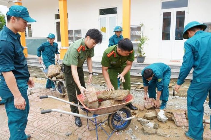 Lực lượng công an, quân sự tham gia chỉnh trang trường học. (Ảnh: CTV)