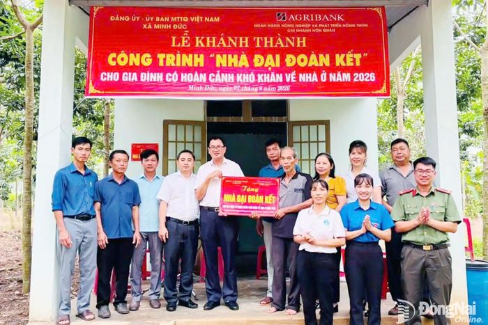 Đại diện Đảng ủy - Ủy ban MTTQ Việt Nam xã Minh Đức bàn giao nhà đại đoàn kết cho một gia đình khó khăn về nhà ở. Ảnh: Hiếu Thanh