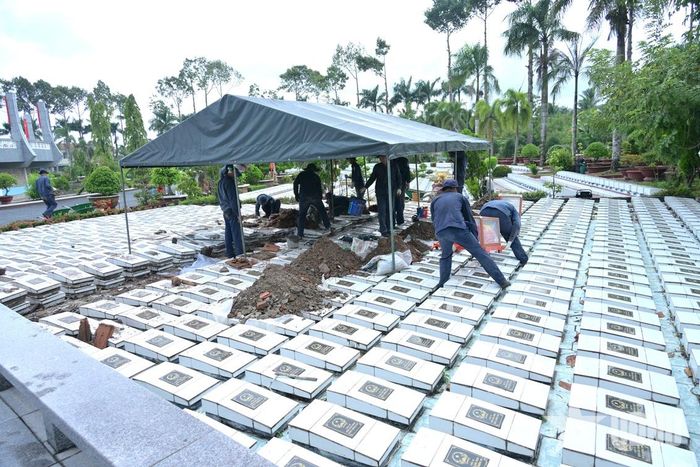 Cán bộ, chiến sĩ Đội K91 tiến hành khai quật các mộ liệt sĩ để lấy mẫu sinh phẩm.