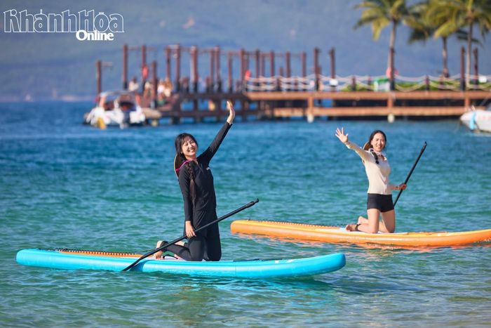 Khách chèo SUP vui chơi ở vùng biển Hòn Tằm.