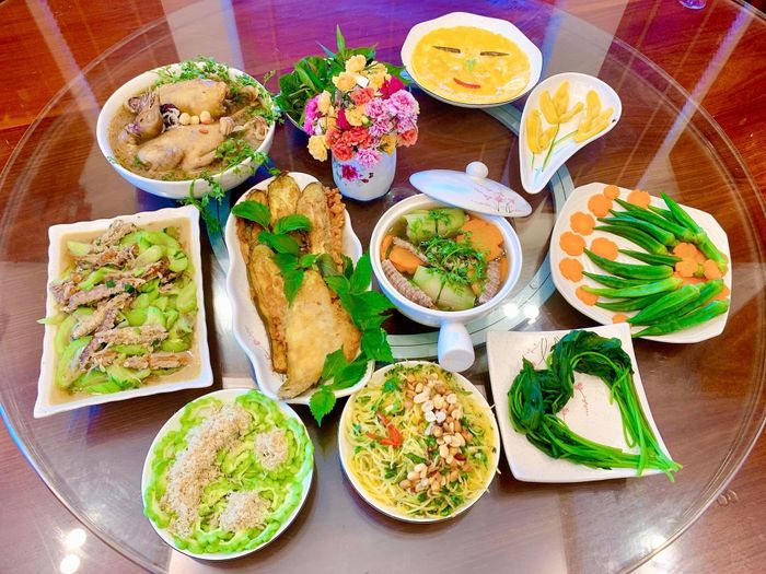Mâm cơm gồm các món chim bồ câu hầm thuốc Bắc; Trứng gà rán; Mướp nhà xào bề bề; Đậu bắp, rau lang; Nộm đu đủ; Mướp đắng; canh bí và cà tím chao bột. Ảnh: Thu Phương
