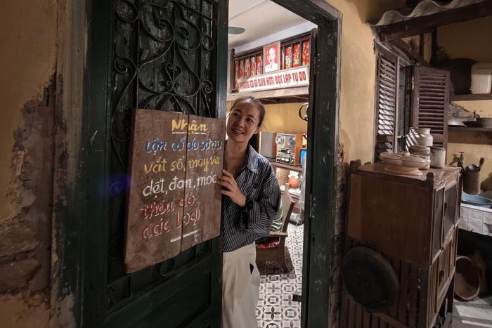 Tấm biển gỗ viết tay "Nhận lộn cổ áo sơ mi, vắt sổ, may vá..." minh chứng cho đức tính cần kiệm của người Tràng An thời tem phiếu vải vóc.