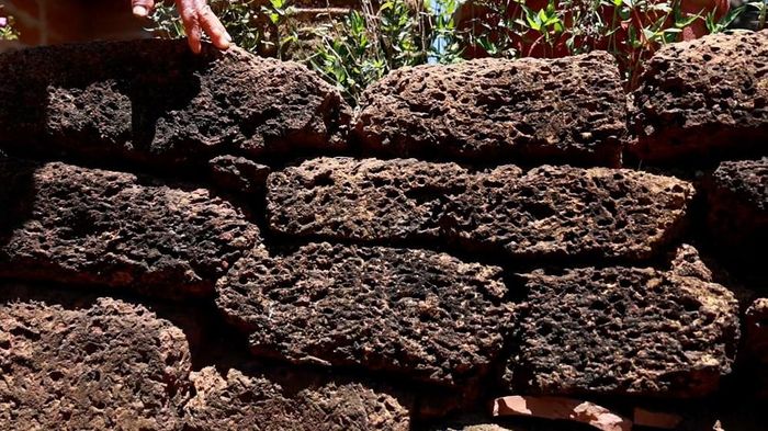 Những bức tường đá ong nâu sẫm, gồ ghề tạo nên nét kiến trúc đặc trưng