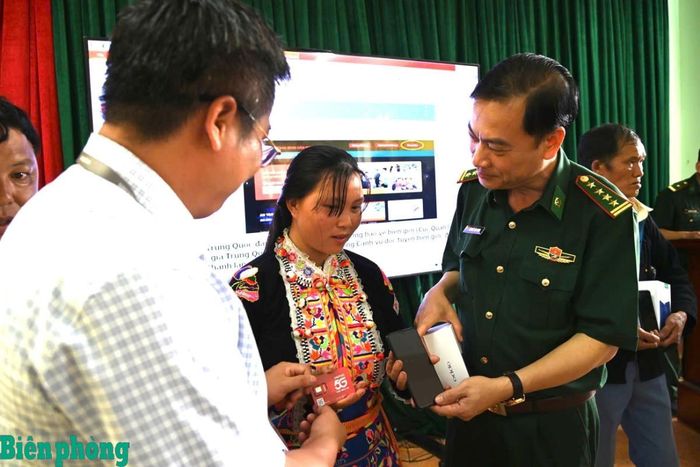 Đại tá Nguyễn Văn Hưng trao điện thoại thông minh kèm thẻ sim tặng đồng bào có hoàn cảnh khó khăn tại bản Sì Choang, xã Sì Lở Lầu, tỉnh Lai Châu. Ảnh: Đức Duẩn