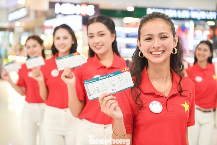 Các thí sinh Hoa hậu Việt Nam cầm trên tay tấm vé đặc biệt của chuyến bay kỷ niệm Quốc khánh.
