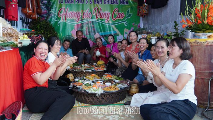 Người dân và du khách thưởng thức các món ăn tại mâm cơm của bản Khiêng Ngà, xã Than Uyên.