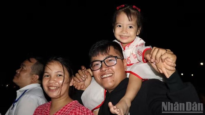 Ba thành viên trong gia đình anh Tăng Võ Khánh Duy háo hức theo dõi chương trình nghệ thuật và màn bắn pháo hoa.