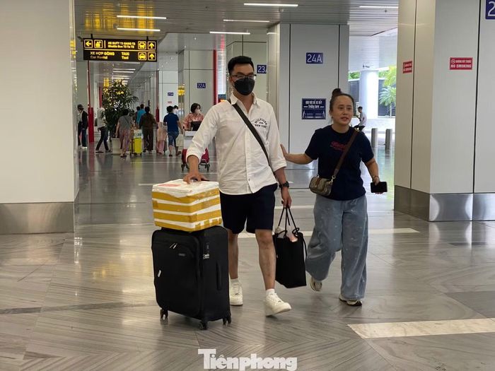 Tại khu vực nhà ga T3, hành khách kéo vali, đẩy xe hành lý di chuyển liên tục nhưng không tạo thành những dòng người chen chúc.