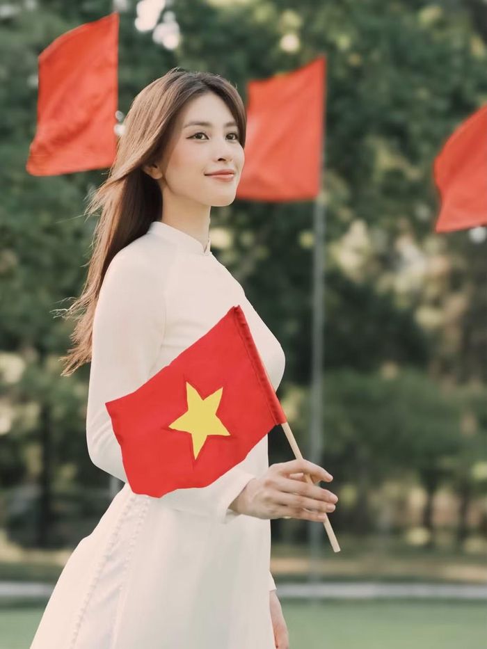 Hoa hậu Tiểu Vy rạng rỡ trong tà áo dài, cầm trên tay lá cờ Tổ quốc, hòa mình vào không khí mừng Quốc khánh 2/9.