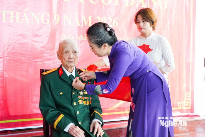 Phó Bí thư Tỉnh ủy Võ Thị Minh Sinh gắn Huy hiệu 80 năm tuổi Đảng cho đảng viên Trần Đình Tuyển. Ảnh: TL