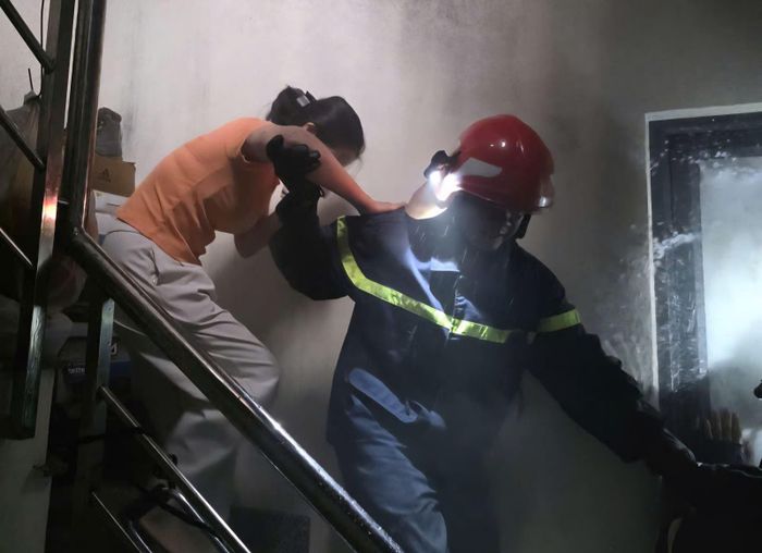 Lực lượng chữa cháy giải cứu những người mắc kẹt trong nhà ra ngoài. Ảnh: CTV