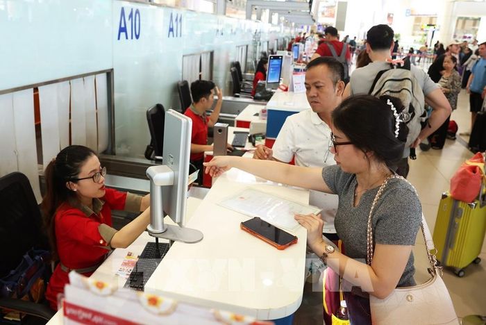 Hành khách làm thủ tục tại quầy của Hãng hàng không VietJet Air, sáng 28/8. Ảnh: Quốc Khánh - TTXVN