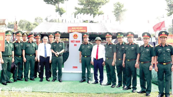 Phó Bí thư Thành ủy, Trưởng ban Tổ chức Thành ủy Thái Bảo (thứ 6 từ phải qua); Ủy viên Ban Thường vụ Thành ủy, Phó Chủ tịch UBND thành phố Lê Trường Sơn và lãnh đạo Bộ Chỉ huy Quân sự thành phố thăm mô hình mốc chủ quyền trong Lễ ra quân huấn luyện năm 2026. Ảnh: Nguyệt Hà