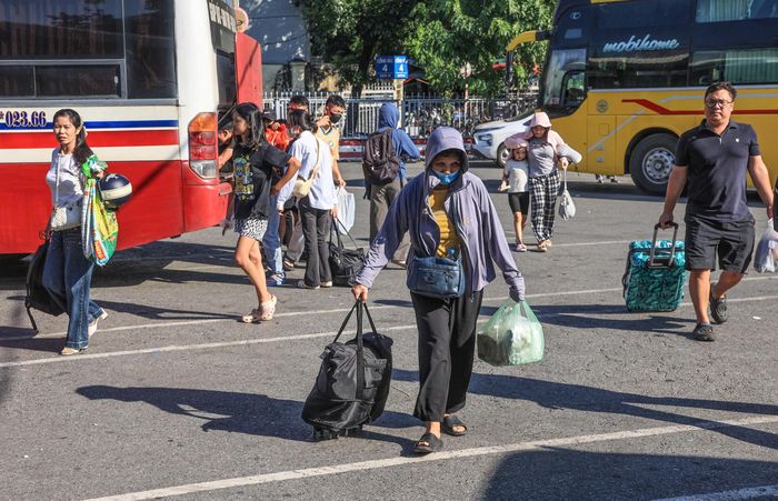 Tại khu vực sảnh chờ và điểm trả khách trong bến xe, người dân mang theo đủ loại hành lý, từ vali, ba lô đến những túi đồ quê. 