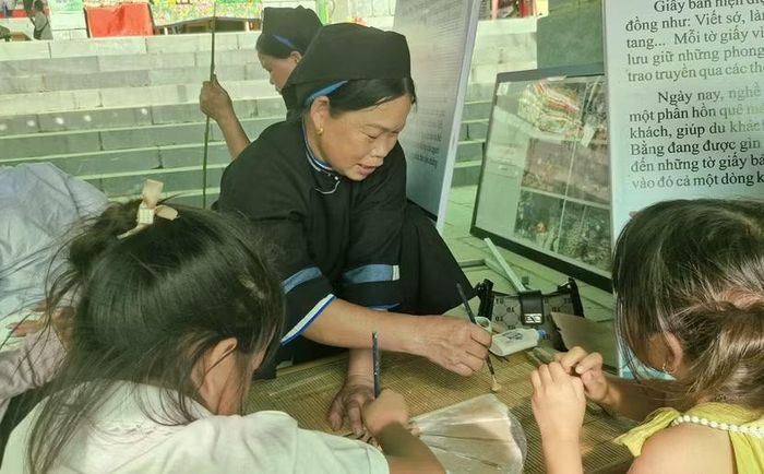 Các bạn nhỏ tham quan, trải nghiệm làm quạt từ giấy bản Dìa Trên.