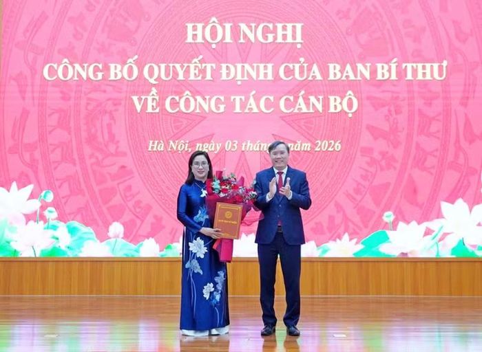 Giáo sư, Tiến sĩ Lê Văn Lợi, Chủ tịch Viện Hàn lâm Khoa học xã hội Việt Nam tặng hoa chúc mừng đồng chí Đinh Thị Mai.