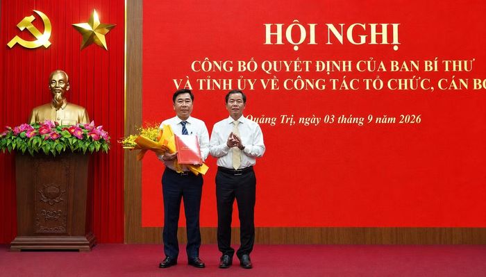 Bí thư Tỉnh ủy Quảng Trị - Nguyễn Văn Phương - trao quyết định và tặng hoa chúc mừng ông Phạm Quang Long.