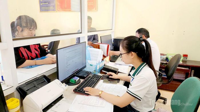 Cán bộ xã Nghĩa Thuận giải quyết thủ tục hành chính cho người dân.