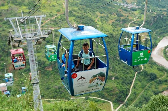  Nhờ hệ thống thang máy và cáp treo, Lei hiện chỉ mất 30 phút để tới trường thay vì 3 giờ như trước đây. Ảnh: Xinhua.