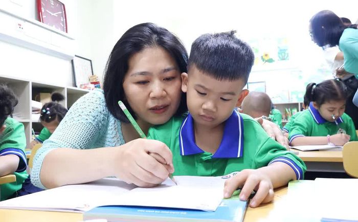 Bệnh nhi ung thư tập viết với sự hướng dẫn của giáo viên tình nguyện tại Lớp học Hoa hướng dương, Bệnh viện Ung bướu Thành phố Hồ Chí Minh. Ảnh: Đinh Hằng - TTXVN