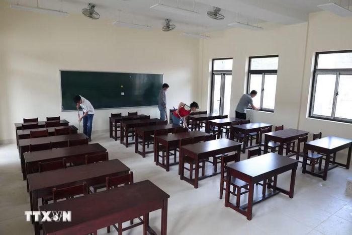 Giáo viên tại Trường Phổ thông nội trú Tiểu học và Trung học Cơ sở xã Tây Giang (thành phố Đà Nẵng) dọn dẹp phòng học ở trường phổ thông nội trú liên cấp mới. (Ảnh: Khoa Chương/TTXVN)
