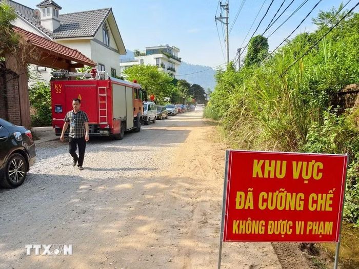 Lực lượng chức năng thiết lập khu vực cưỡng chế, bố trí phương tiện phòng cháy, chữa cháy và bảo đảm an toàn tại hiện trường. (Ảnh: Trung Nguyên/TTXVN)