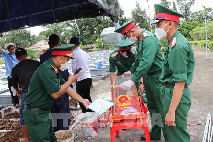 Các chiến sĩ lấy mẫu tại Nghĩa trang Liệt sĩ Tiểu Cần theo đúng quy trình kỹ thuật, phục vụ giám định ADN. Ảnh: Thanh Hòa - TTXVN