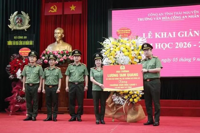 Đại tá Tô Long-Cục trưởng Cục An ninh Đối ngoại tặng hoa và quà của Đảng ủy Công an Trung ương và Đại tướng Lương Tam Quang, Uỷ viên Bộ Chính trị, Bộ trưởng Bộ Công an chúc mừng nhà trường. (Ảnh: CAND)