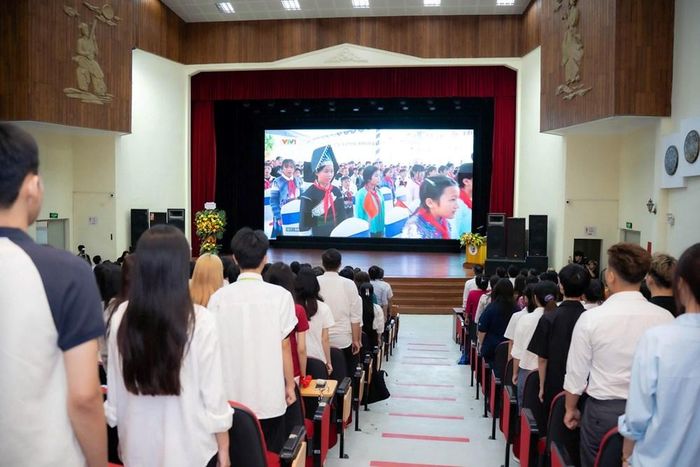 Thầy cô, sinh viên thực hiện nghi thức chào cờ từ điểm cầu Trường Đại học Văn hóa Hà Nội