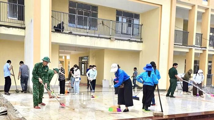 Bộ đội Biên phòng và đoàn viên thanh niên tình nguyện chung tay thu dọn vệ sinh ở trường mới cho học sinh vùng cao Quảng Trị kịp ngày khai giảng. (Ảnh: HG)