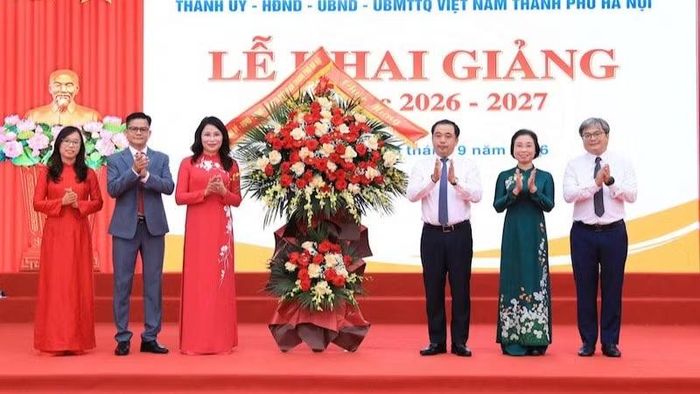 Bí thư Thành ủy Hà Nội tặng hoa chúc mừng Trường trung học cơ sở Trần Duy Hưng. (Ảnh: Thái Quang)