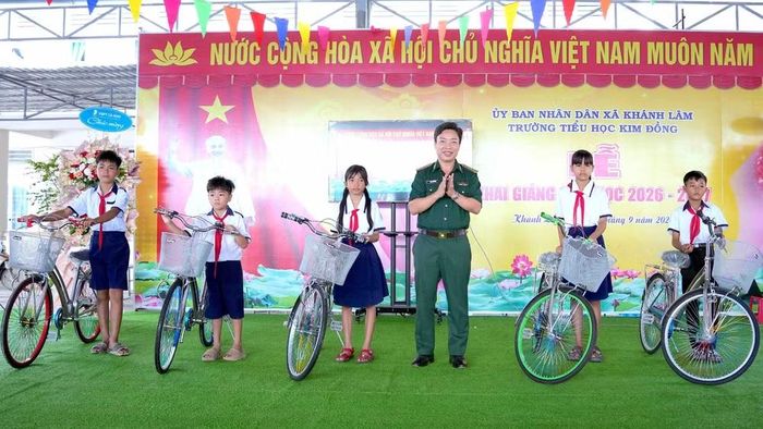 Đại tá Phạm Minh Giang, Bí thư Đảng ủy, Chính ủy Bộ đội Biên phòng Cà Mau, tặng xe đạp động viên các em học sinh tại Trường tiểu học Kim Đồng (xã Khánh Lâm, tỉnh Cà Mau). (Ảnh: HOÀNG TÁ)