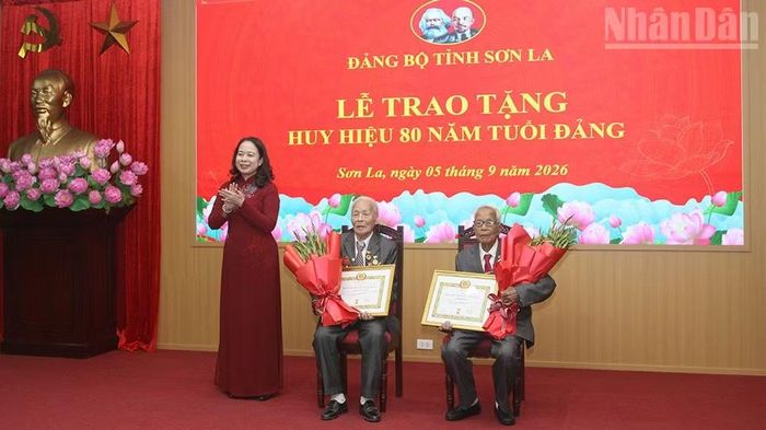 Đồng chí Võ Thị Ánh Xuân, Bí thư Trung ương Đảng, Phó Chủ tịch nước đã thay mặt lãnh đạo Đảng, Nhà nước trao Huy hiệu 80 năm tuổi Đảng, tặng hoa chúc mừng 2 đảng viên lão thành thuộc Đảng bộ tỉnh Sơn La. (Ảnh: QUỐC TUẤN)