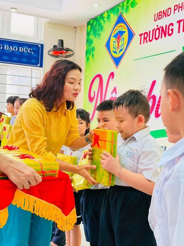 Cô Nguyễn Thụy Hạ Dung, Trường Tiểu học Lê Lai trao sách giáo khoa cho học sinh có hoàn cảnh khó khăn.