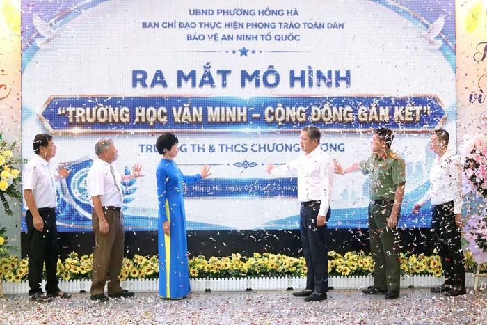 Các đại biểu cùng thực hiện nghi thức bấm nút ra mắt mô hình "Trường học văn minh - Cộng đồng gắn kết".