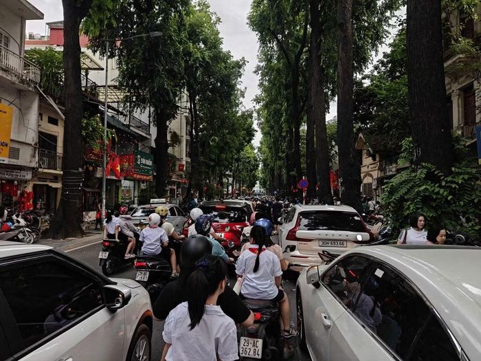 Bên cạnh đó, nhiều xe ô tô dừng đỗ gần cổng trường khiến lòng đường bị thu hẹp.