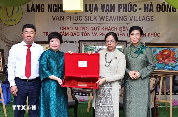 Trao tặng quà cho Phu nhân Kyu Kyu Hla tại làng lụa Vạn Phúc. (Ảnh: Minh Đức/TTXVN)