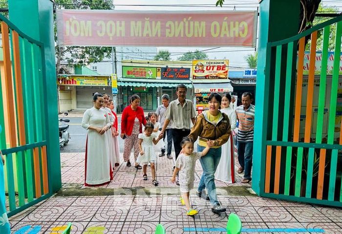 Phụ huynh đưa trẻ đến Trường Mầm non Thái Chánh trong ngày đầu năm học mới. Ảnh: Giang Phương - TTXVN