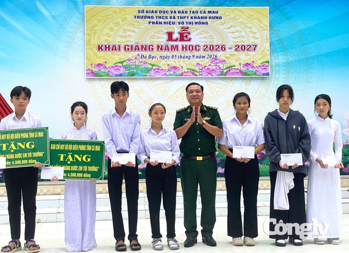 Trung tá Trương Văn Kết, Chính trị viên Đồn Biên phòng Sông Đốc tặng học bổng cho các em học sinh Trung học cơ sở và Trung học phổ thông Khánh Hưng (xã Đá Bạc, Cà Mau)