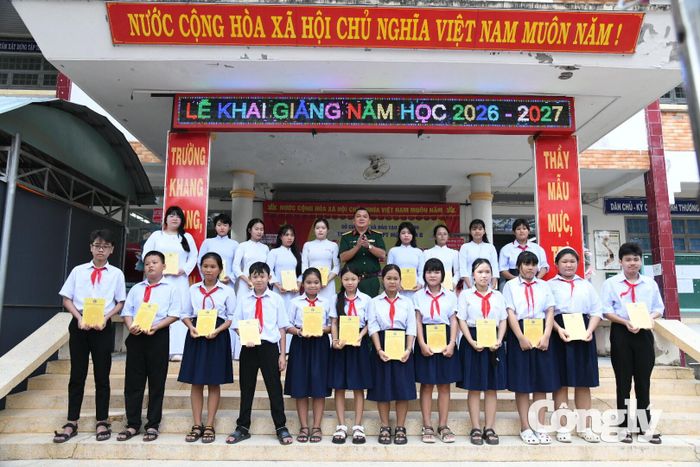 Đại tá Trần Văn Cư - Chỉ huy trưởng Bộ CHQS tỉnh tặng học bổng cho các em học sinh giỏi, học sinh xuất sắc.
