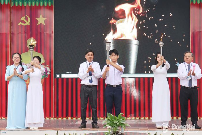 Ban giám hiệu nhà trường trao những ngọn đuốc chào mừng học sinh mới vào trường năm học 2026-2027. Ảnh: Nguyệt Hà