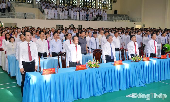 Các đại biểu tham dự lễ thực hiện nghi thức chào cờ và hát Quốc ca chung cả nước.