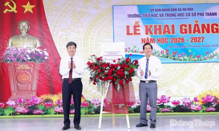 Đồng chí Phạm Văn Chuẩn (bên trái), Ủy viên Ban Thường vụ Tỉnh ủy, Phó Chủ tịch Thường trực HĐND tỉnh Đồng Tháp tặng hoa chúc mừng Trường Tiểu học và THCS Phú Thành nhân dịp khai giảng năm học 2026 - 2027.