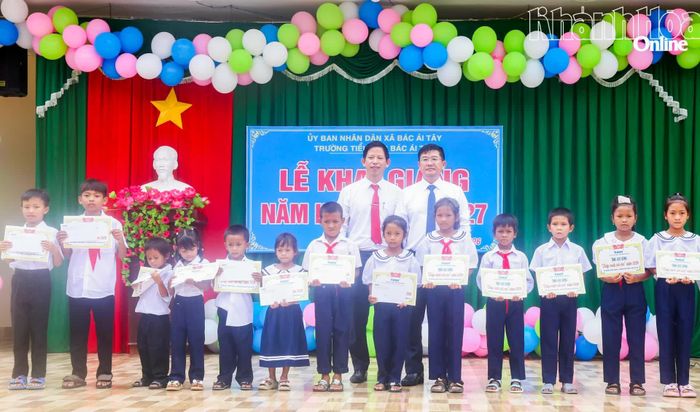 Lãnh đạo Báo và Phát thanh, Truyền hình Khánh Hòa và lãnh đạo UBND xã Bác Ái Tây trao học bổng cho các em học sinh.