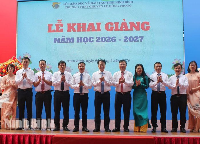 Đồng chí Chủ tịch UBND tỉnh Nguyễn Thanh Bình và các đại biểu chụp ảnh lưu niệm với cán bộ, giáo viên Trường THPT chuyên Lê Hồng Phong.