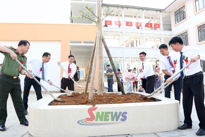 Các đại biểu trồng cây lưu niệm tại khuôn viên nhà trường.