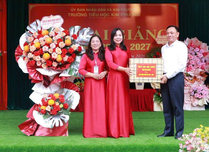 Đồng chí Phạm Văn Thọ, Ủy viên Ban Thường vụ Tỉnh ủy, Giám đốc Sở Công Thương tặng quà chúc mừng cô và trò Trường Tiểu học Kim Phượng.