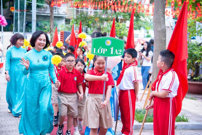 Cô Phạm Minh Thảo - Hiệu trưởng Trường tiểu học Thành Công dắt tay chào đón các em học sinh lớp 1 trong buổi Lễ khai giảng